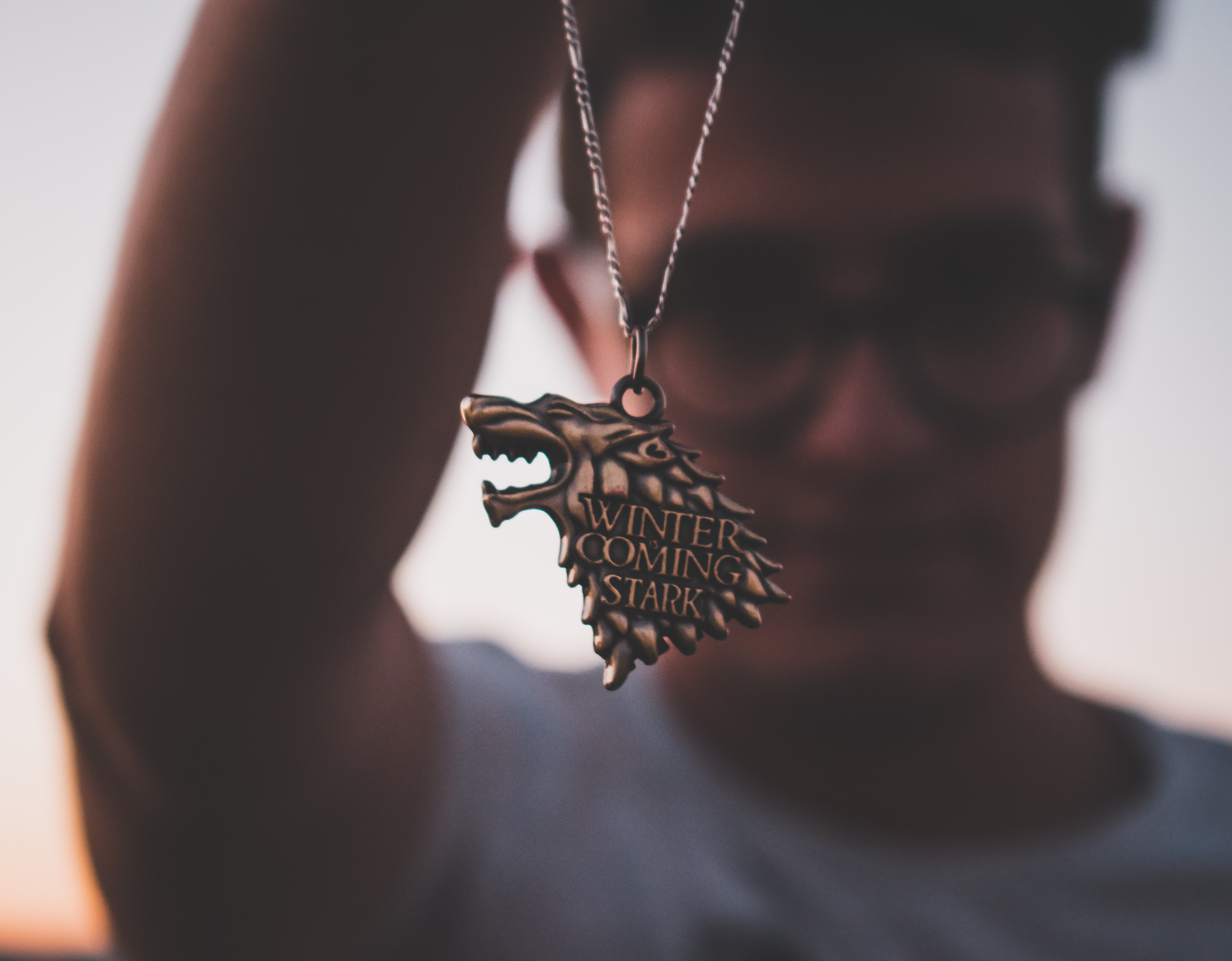 A man holding a Game of Thrones necklace