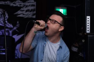 man holding a microphone singing karaoke