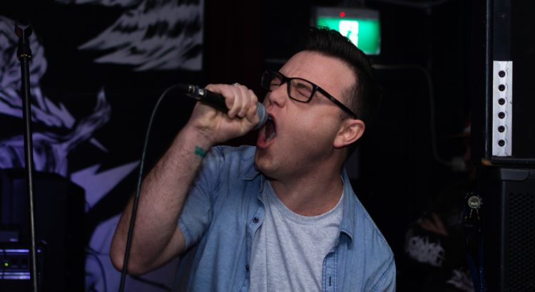 man holding a microphone singing karaoke