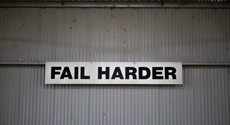 a sign on the wall that says fail harder