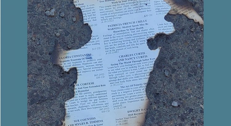 a burnt piece of paper on the sidewalk