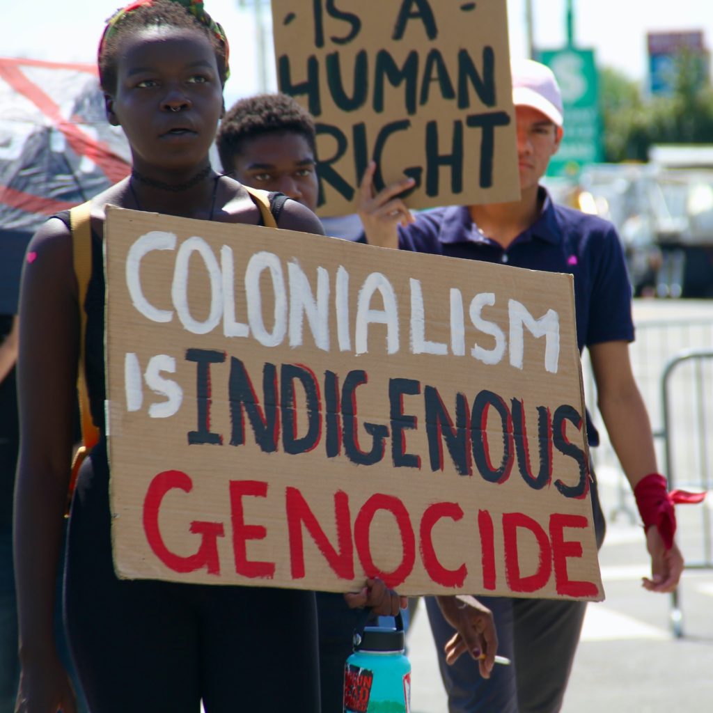 black woman holding a protest sign