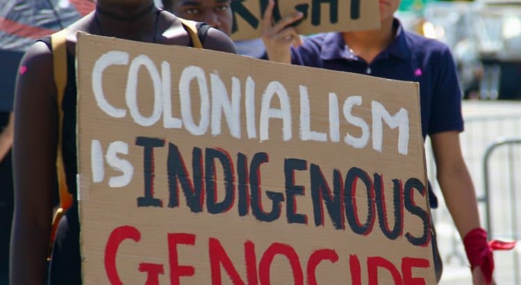 black woman holding protest sign