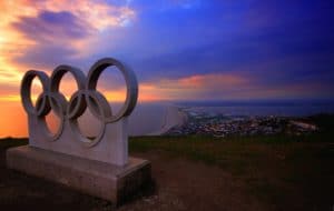 concrete olympic rings overlooking a city