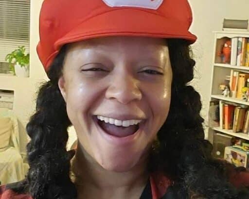 photo of the author Sylvie Soulet wearing a Mario hat and her hair in pigtails